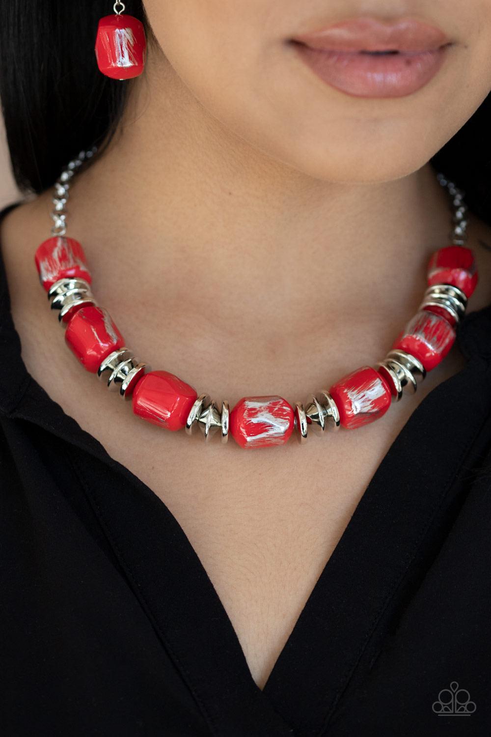 Paparazzi Accessories Girl Grit - Red Featuring a scratched metallic finish, faceted red beads and shimmery silver accents are threaded along an invisible wire below the collar for a colorful look. Features an adjustable clasp closure. Sold as one individ