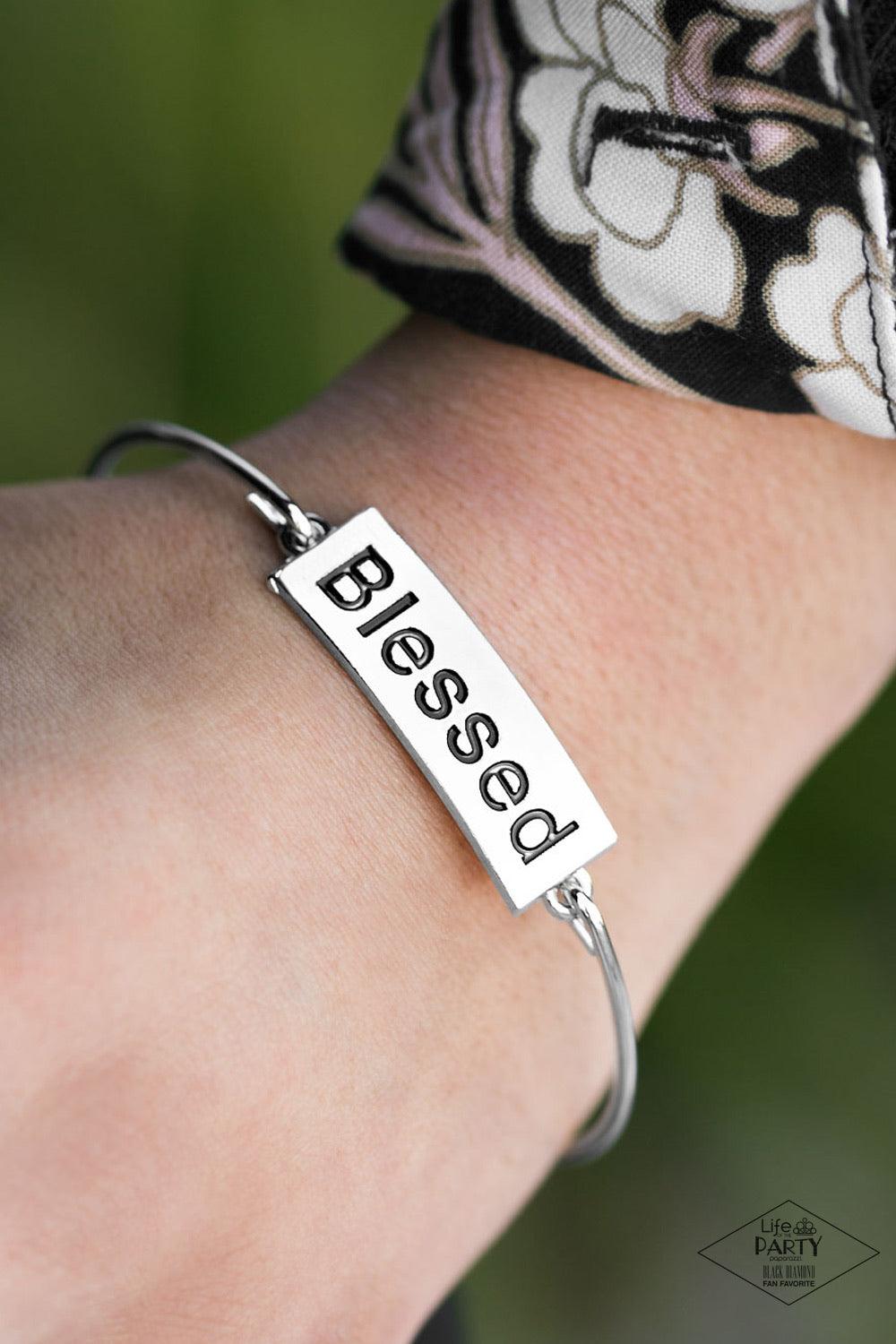 Paparazzi Accessories Blessed - Silver Engraved with the inspiring word "Blessed", a shimmery silver plate attaches to a skinny silver bar, creating a dainty bangle. Jewelry