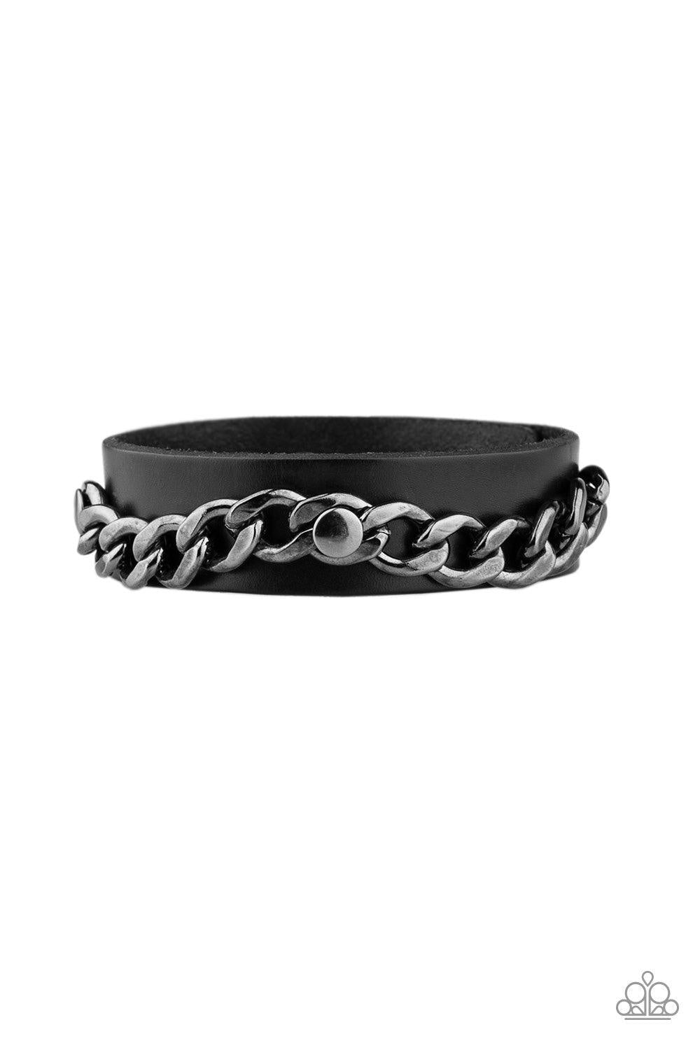 Paparazzi Accessories Be The CHAINage - Black A glistening gunmetal chain is studded in place across the front of a black leather band for an urban look. Features an adjustable snap closure. Jewelry