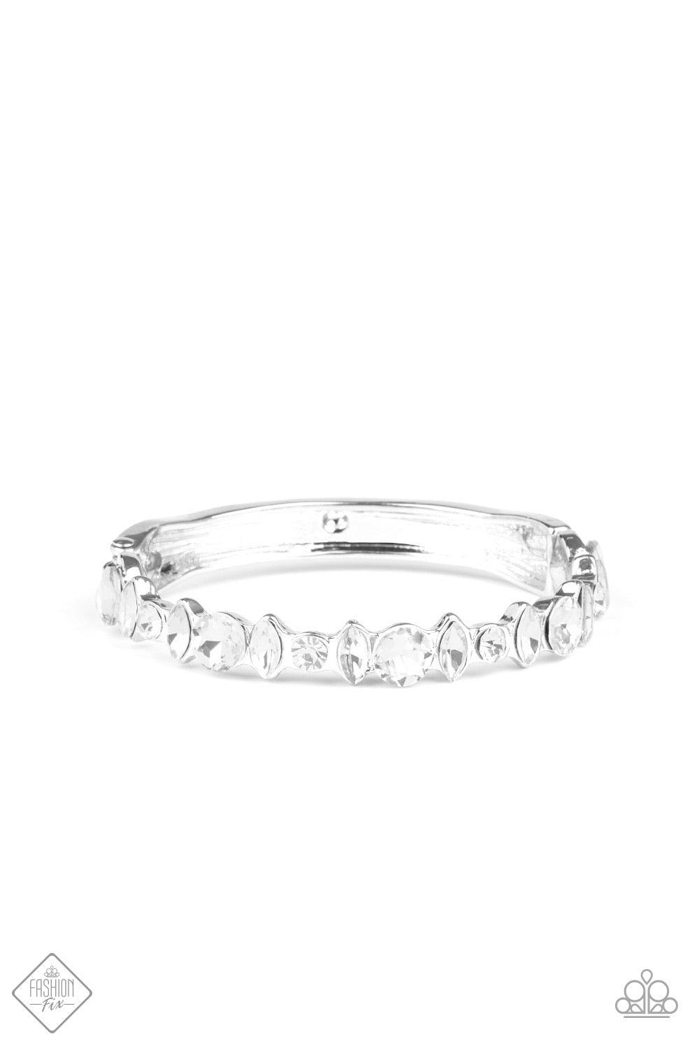 Paparazzi Accessories BLING Them To There Knees - White A blinding collection of round and marquise-cut white rhinestones are encrusted across the front of a shiny silver bar, curling around the wrist to create a timeless cuff-like bangle. Features a hing