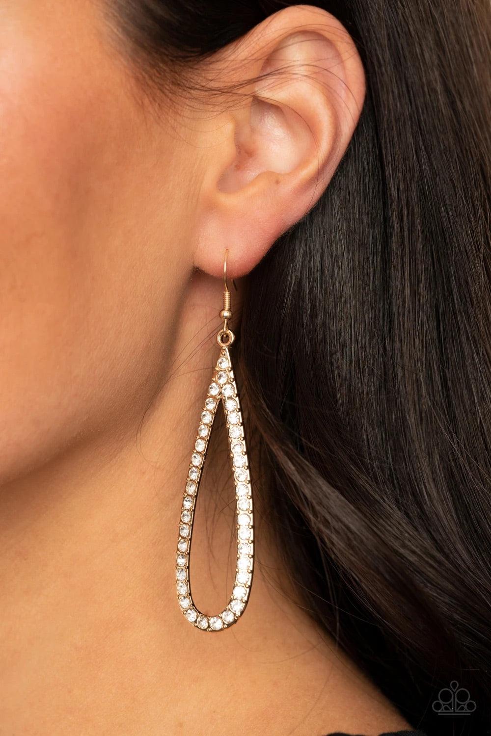 Paparazzi Accessories Glitzy Goals - Gold Glittery white rhinestones are encrusted along the front of an elongated gold teardrop, creating a glitzy lure. Earring attaches to a standard fishhook fitting. Sold as one pair of earrings. Jewelry
