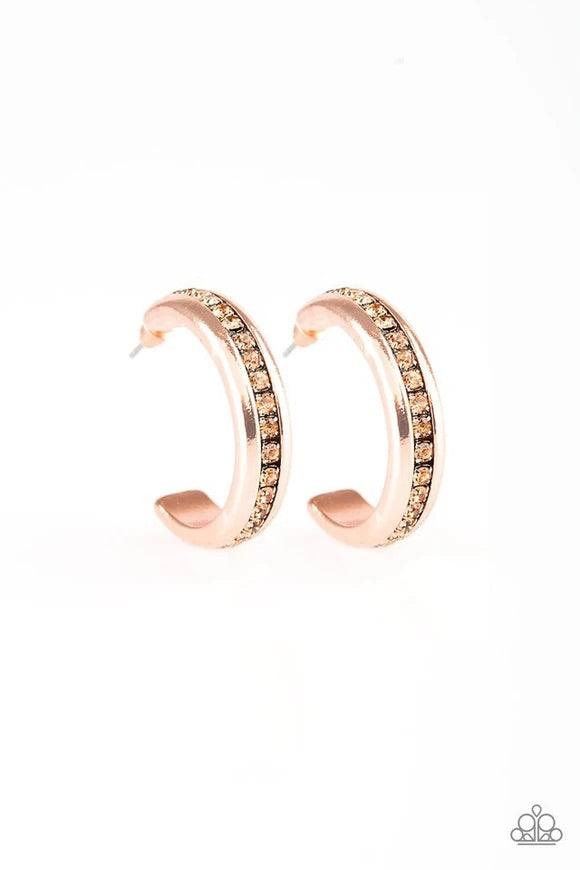 Paparazzi Accessories 5th Avenue Fashionista - Copper A row of glassy topaz rhinestones is encrusted down the spine of a shiny copper hoop for a refined look. Earring attaches to a standard post fitting. Hoop measures 1 1/4" in diameter. Sold as one pair