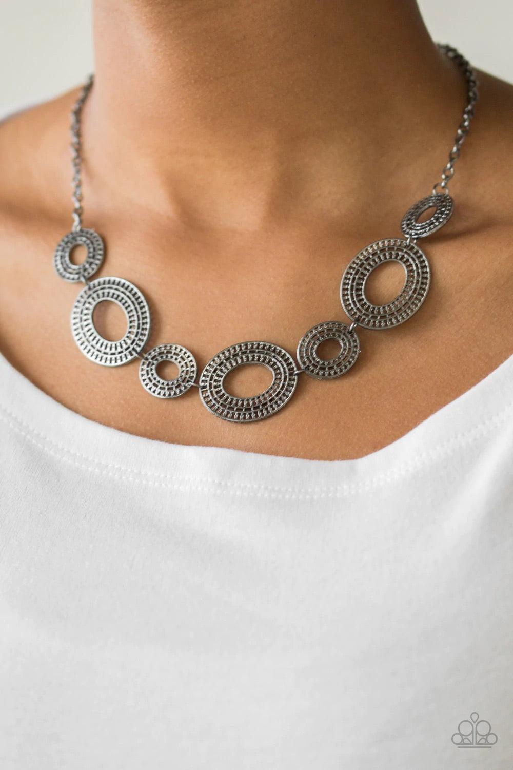Paparazzi Accessories Basically Baltic - Black Radiating with circular details, airy oval frames link below the collar for a casual look. Features an adjustable clasp closure. Sold as one individual necklace. Includes one pair of matching earrings. Jewelr