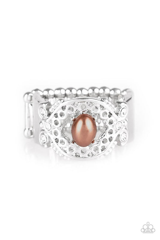 Paparazzi Accessories Mod Modest - Brown Dotted with glittery white rhinestones, an airy filigreed silver band arcs across the finger in a regal fashion. A pearly brown bead is pressed into the center of the band for a timeless finish. Features a stretchy