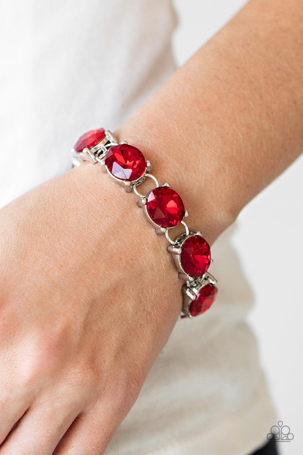 Paparazzi Accessories Mind Your Manners - Red Featuring sleek silver settings, a blinding collection of oversized red rhinestones dramatically link across the wrist for a glamorous fashion. Features an adjustable clasp closure. Sold as one individual brac