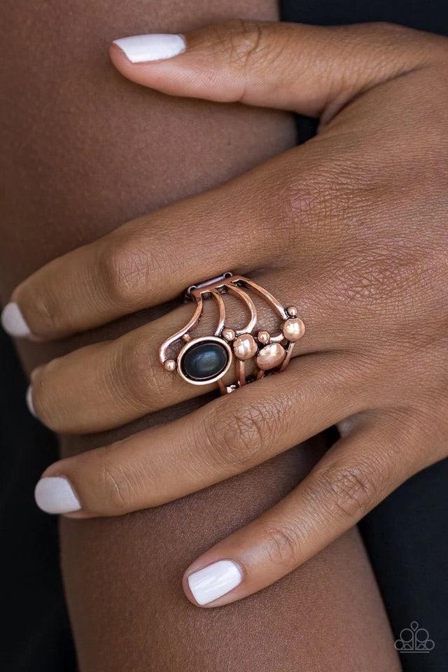 Paparazzi Accessories Wanderlust Wanderer ~Copper Dotted with bubbly copper frames, glistening copper bars swoop across the finger. An earthy black stone is pressed into the top of the whimsically stacked frame for a seasonal finish. Features a stretchy b