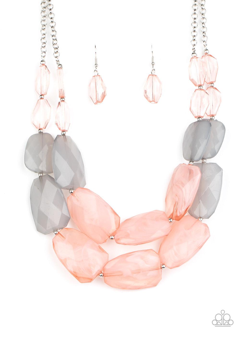 Paparazzi Accessories Gives Me Chills - Pink Varying in shape and size, opaque pink and gray crystal-like beads delicately link into two colorfully icy layers below the collar for a stunning statement-making finish. Features an adjustable clasp closure. S
