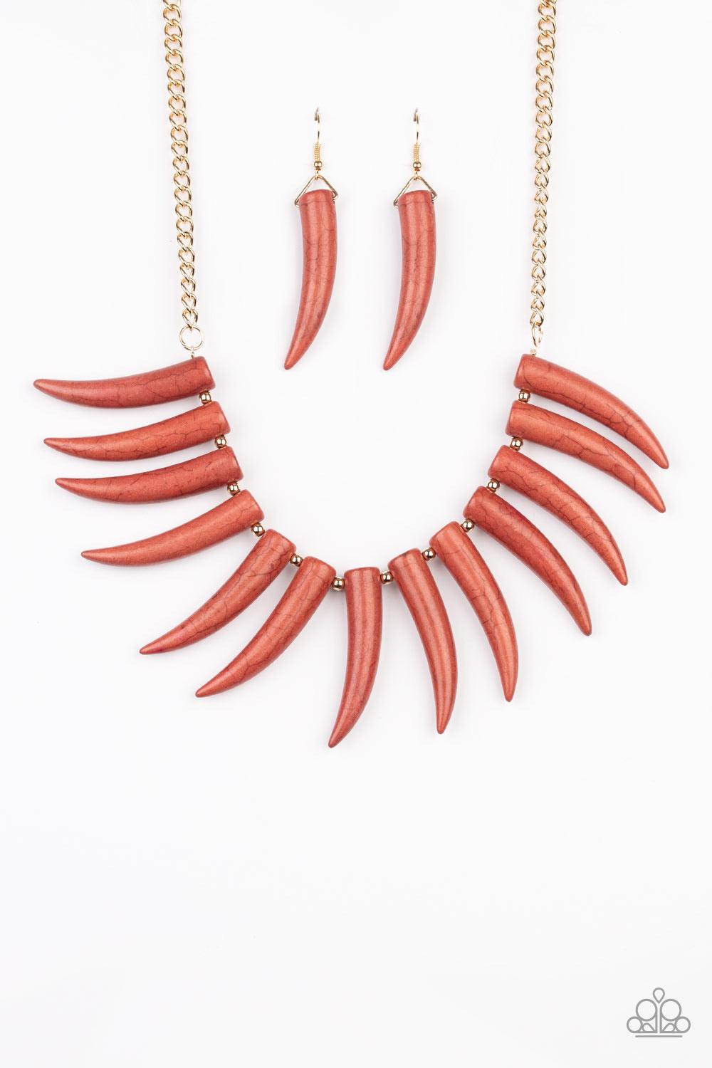 Paparazzi Accessories Tusk Tundra - Brown Infused with dainty gold beads, tusk-shaped Cinnamon Stick stone beads are threaded along an invisible wire below the collar, creating a wild fringe. Features an adjustable clasp closure. Sold as one individual ne