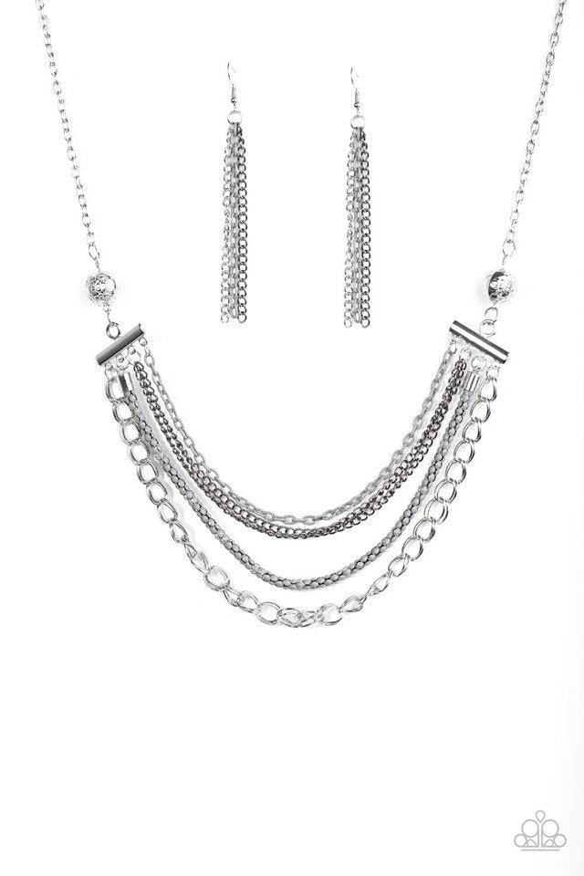 Paparazzi Accessories High-Intensity - Silver Two floral silver beads give way to an array of gray, gunmetal, and silver chains. Strung between two metal beads, the mismatched chains layer below the collar in a colorfully industrial fashion. Features an a