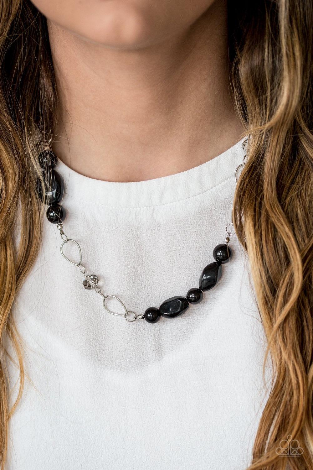 Paparazzi Accessories Bean Away - Black Featuring polished and glassy finishes, black beads trickle below the collar in a refined fashion. Faceted crystal-like beads and teardrop shaped frames are sprinkled between the colorful accents for a beaming finis