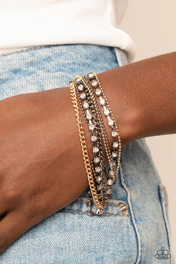 Paparazzi Accessories Secretly Sassy - Multi Glittery strands of white rhinestones join layers of gold and gunmetal ball and classic chains around the wrist, resulting in edgy shimmer. Features an adjustable clasp closure. Sold as one individual bracelet.