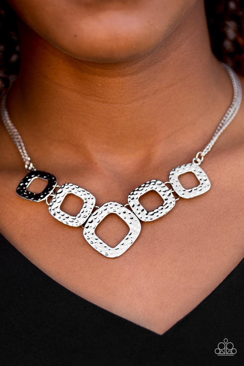 Paparazzi Accessories Wild Catch ~Silver Delicately hammered in shimmery textures, asymmetrical square silver frames link below the collar in a bold artisanal fashion. Features an adjustable clasp closure. Sold as one individual necklace. Includes one pai