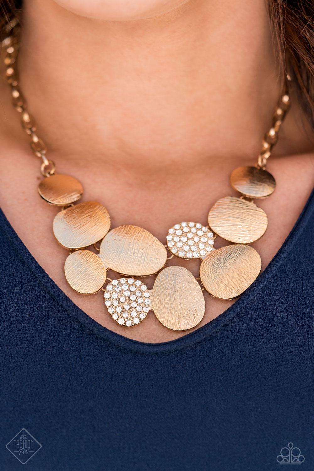 Paparazzi Accessories A Hard LUXE Story - Gold A collection of asymmetrical oval discs connect into a clustered pendant below the collar for a refined flair. Etched linear textures or white rhinestones adorn each disc, offering a gorgeous collision of tex