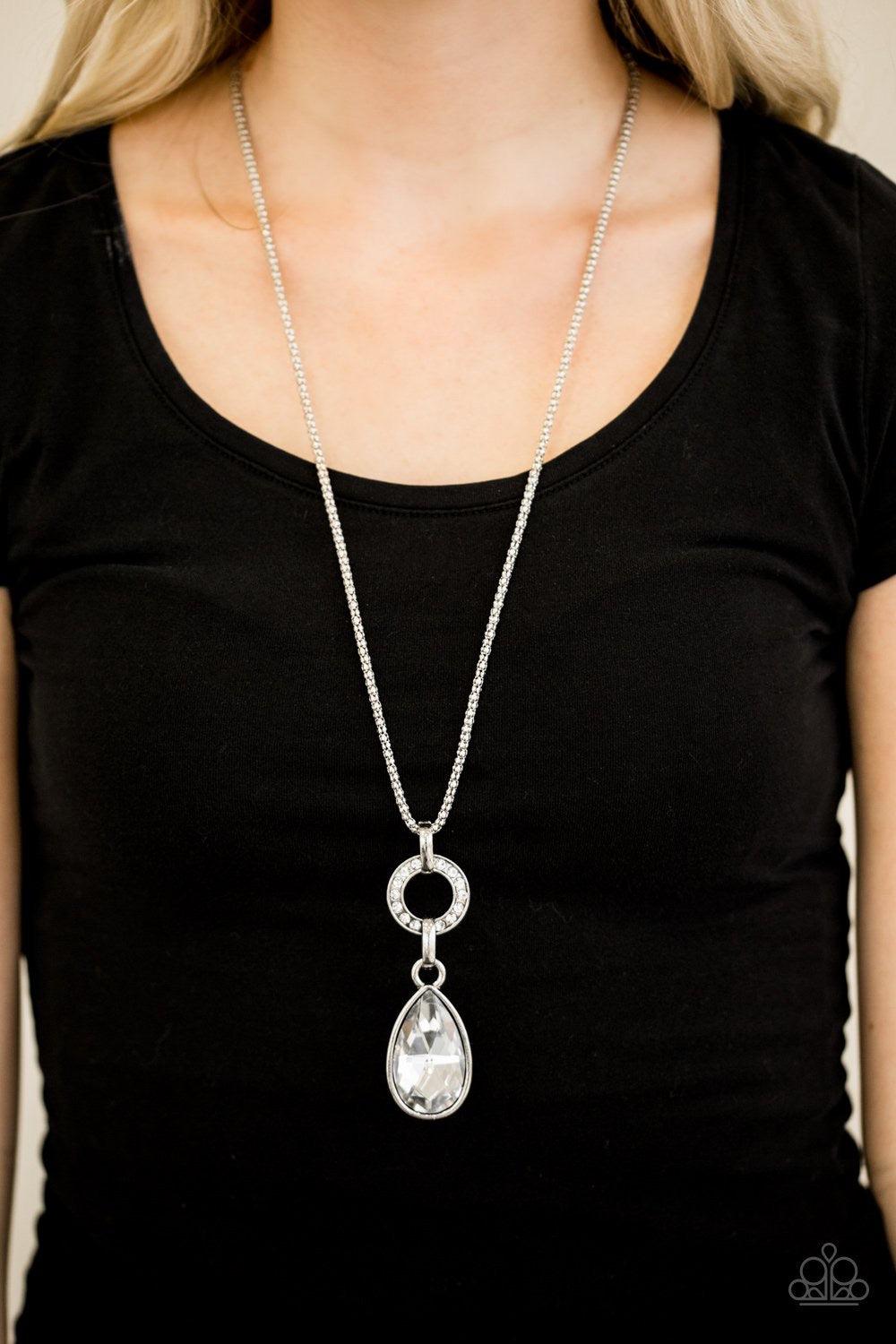 Paparazzi Accessories Lookin’ Like A Million - White Encrusted in glittery white rhinestones, a shimmer silver ring gives way to a dramatic glassy white teardrop. The impressive pendant slides along a shimmer silver popcorn chain for a refined look. Featu