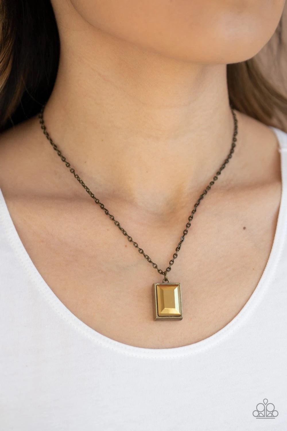 Paparazzi Accessories Pro-Edge - Brass Featuring an emerald style cut, a faceted aurum gem is pressed into a sleek brass frame at the bottom of a dainty brass chain below the collar for an edgy look. Features an adjustable clasp closure. Sold as one indiv