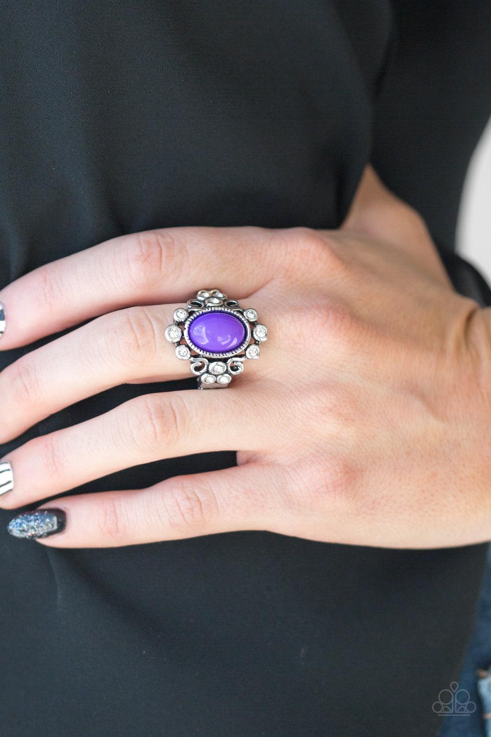 Paparazzi Accessories Noticeably Notable - Purple A polished purple bead is pressed into a bubbly silver frame radiating with glassy white rhinestones for a notable finish. Features a stretchy band for a flexible fit. Sold as one individual ring. Jewelry