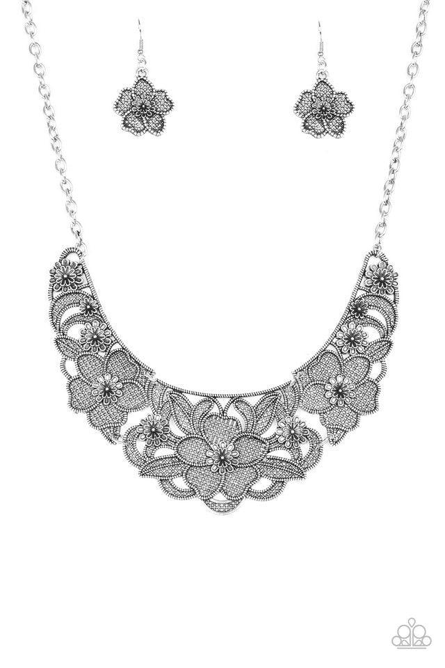 Paparazzi Accessories Petunia Paradise - Silver Featuring lattice-like patterns, shimmery silver flowers bloom below the collar for a seasonal look. Features an adjustable clasp closure. Sold as one individual necklace. Includes one pair of matching earri