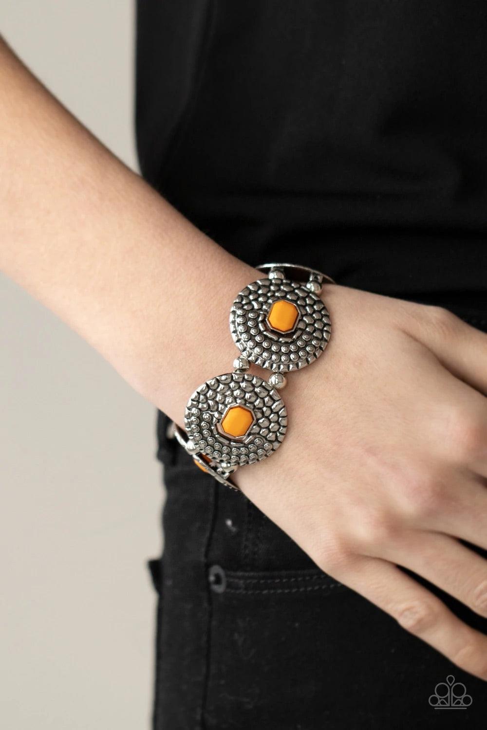 Paparazzi Accessories Prismatic Prowl - Orange Marigold emerald shaped beads adorn the centers of round silver discs studded and embossed in metallic croc-like textures. Infused with pairs of silver beads, the decorative frames are threaded along stretchy