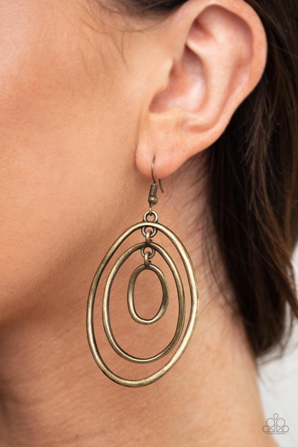 Paparazzi Accessories Retro Ruins - Brass A trio of imperfect brass ovals link into a rippling lure for a dizzying look. Earring attaches to a standard fishhook fitting. Sold as one pair of earrings. Jewelry