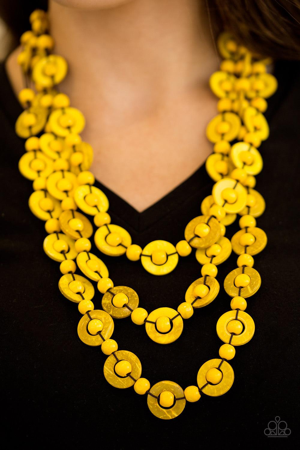 Paparazzi Accessories Bermuda Belle - Yellow Brushed in a refreshing yellow finish, wooden rings and beads are knotted in place along three strands, creating summery layers down the chest. Features a button loop closure. Jewelry