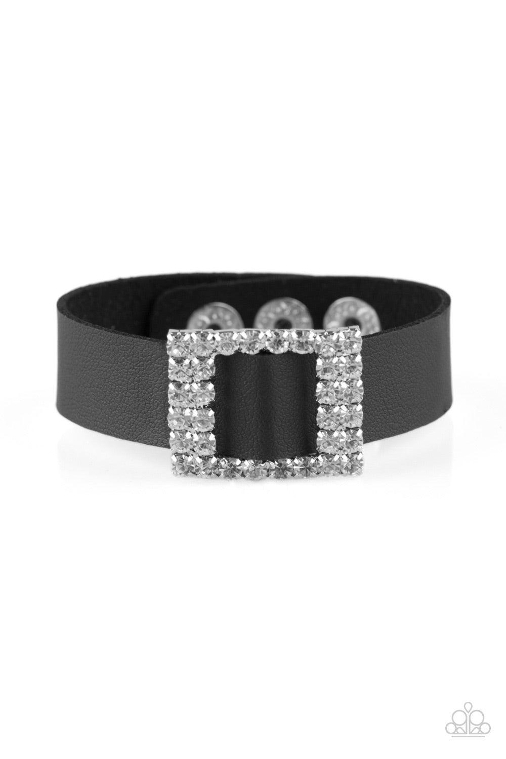 Paparazzi Accessories Diamond Diva ~Black Encrusted in glassy white rhinestones, a dazzling frame slides along a strip of black leather, creating a blinding centerpiece atop the wrist. Features an adjustable snap closure.