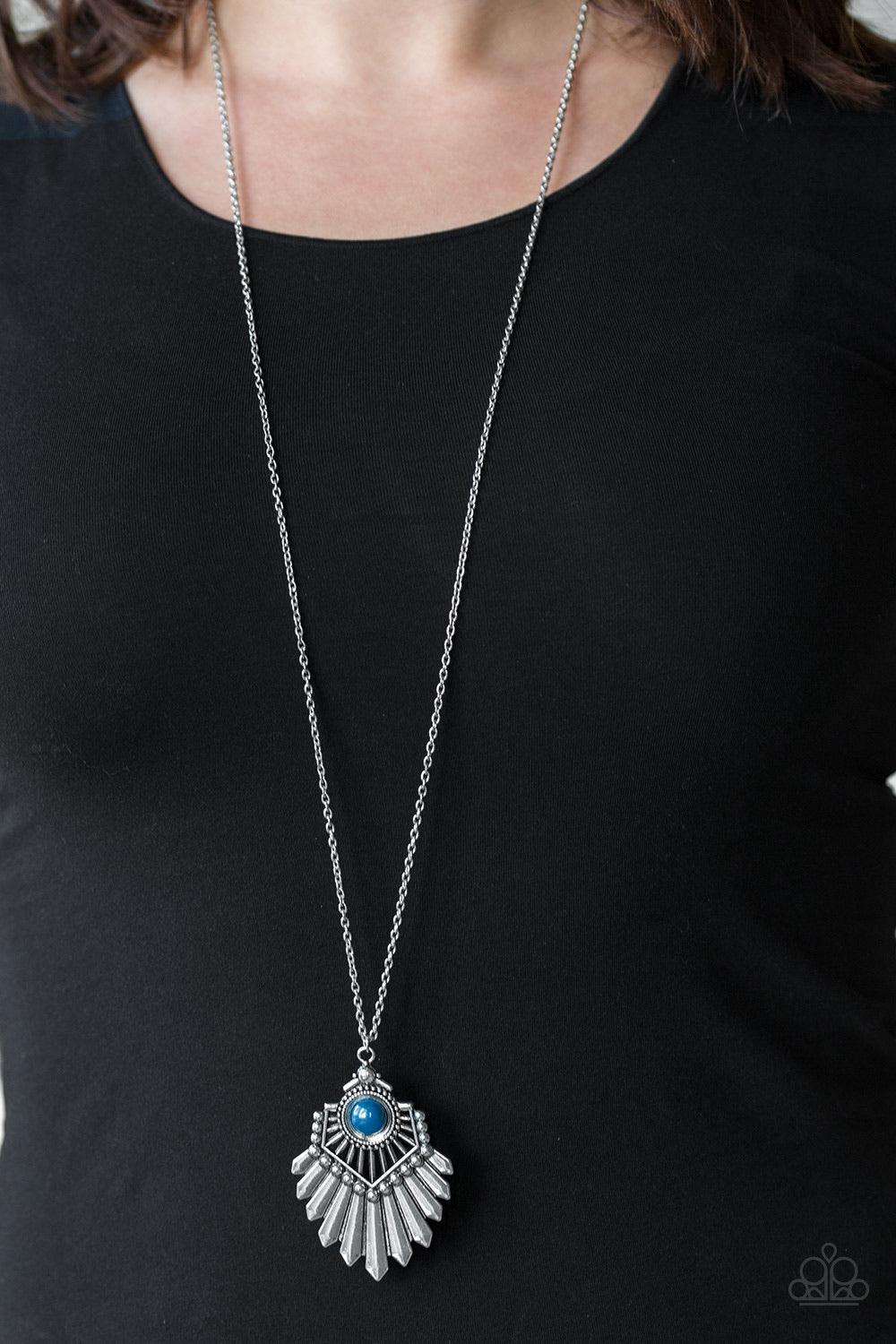 Paparazzi Accessories Inde-PENDANT Idol - Blue Infused with a lengthened silver chain, a polished blue bead is pressed into the center of a flared silver pendant for a bold tribal flair. Features an adjustable clasp closure. Sold as one individual necklac