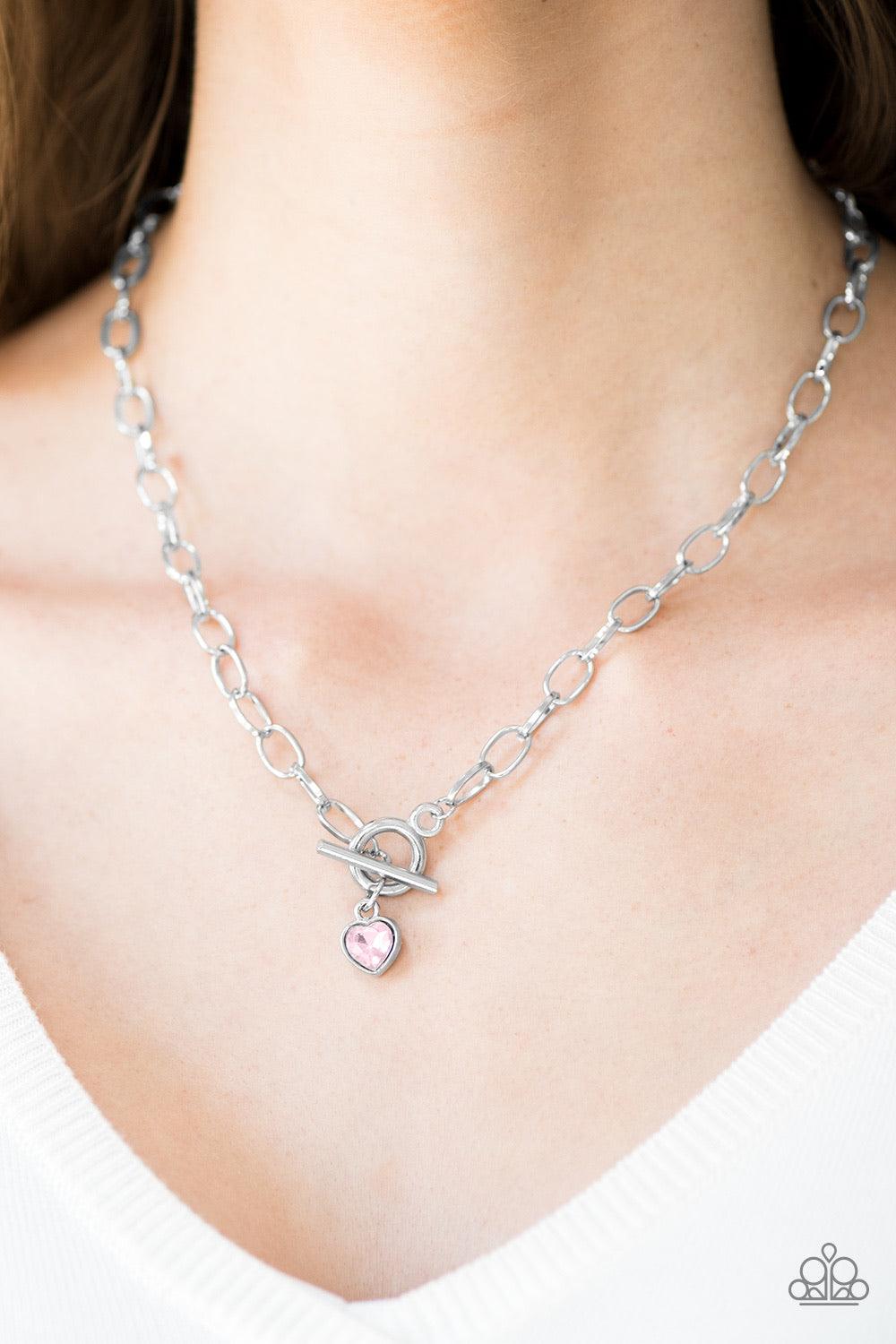 Paparazzi Accessories Let Your Heart Shine - Pink Featuring an elegant lariat centerpiece, a glittery pink gem is pressed into a silver heart frame, creating a timeless pendant below the collar. Features a toggle clasp. Sold as one individual necklace. In