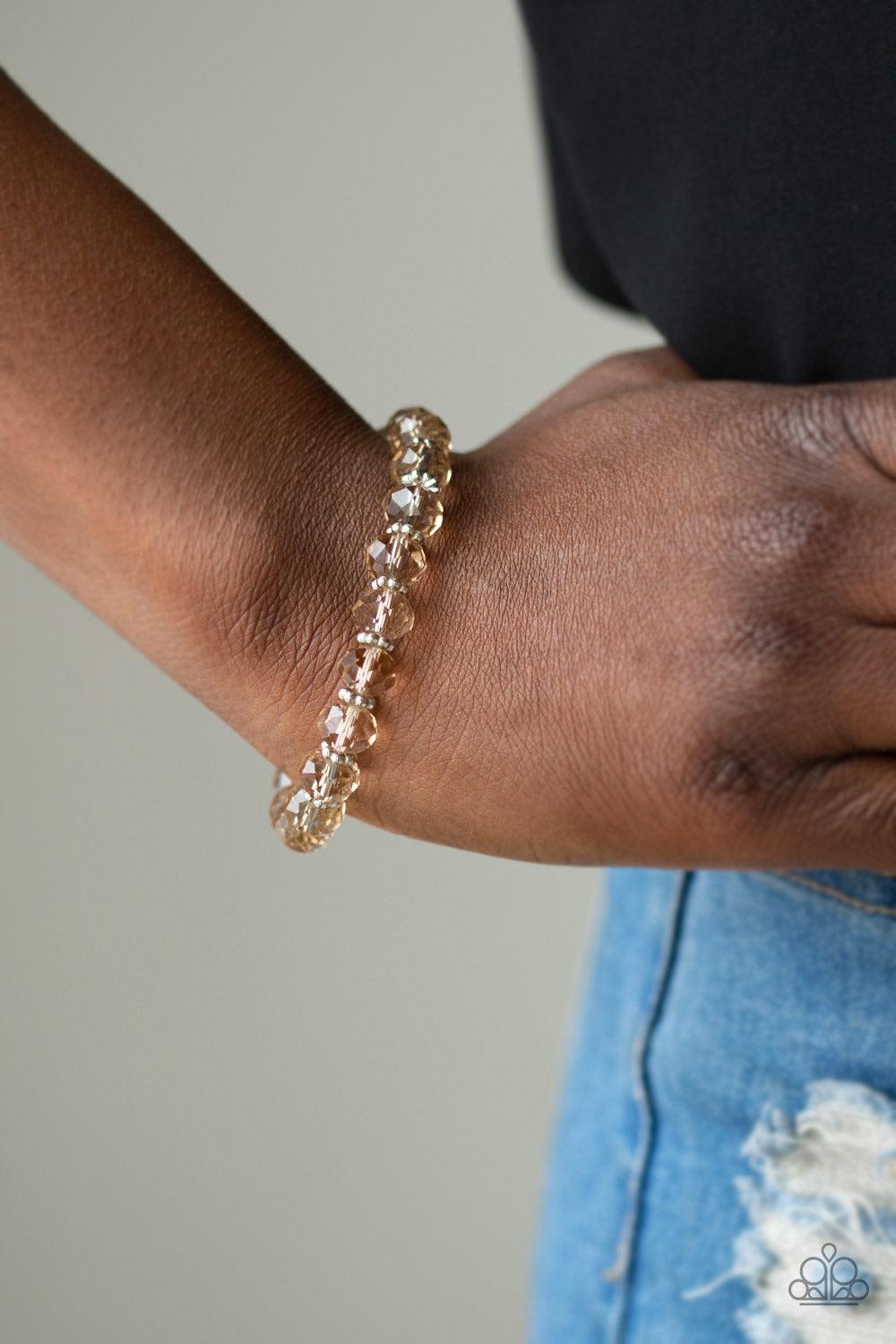 Paparazzi Accessories Crystal Candelabras - Brown Glittery crystal-like beads and studded silver rings are threaded along a stretchy band around the wrist for a sophisticated look. Jewelry