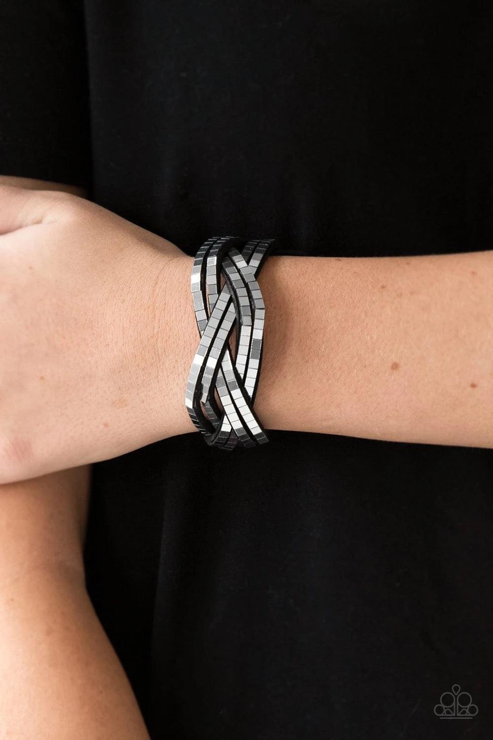 Paparazzi Accessories Looking For Trouble - Silver Flat silver cubes are encrusted along rows of braided gray suede for an edgy look. Features an adjustable snap closure. Sold as one individual bracelet. Jewelry