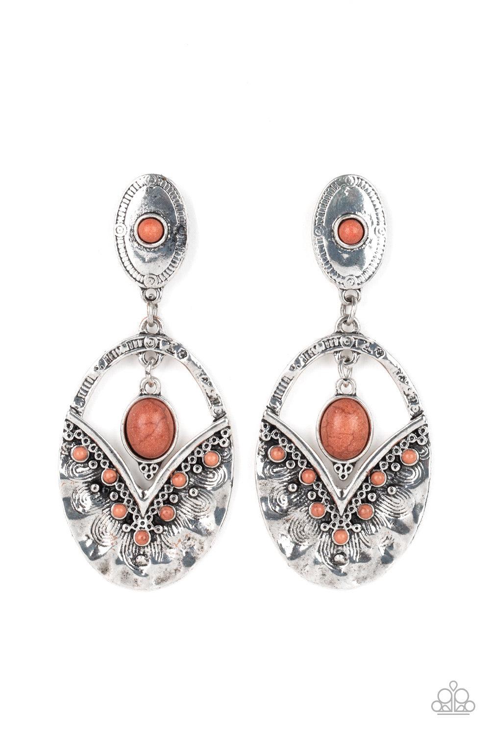 Paparazzi Accessories Terra Tribute - Brown Rippling with hammered silver textures, a brown stone dotted frame swings from the bottom of an ornate oval frame dotted with a matching brown stone. A smooth brown stone swings from the top of the ornate frame,