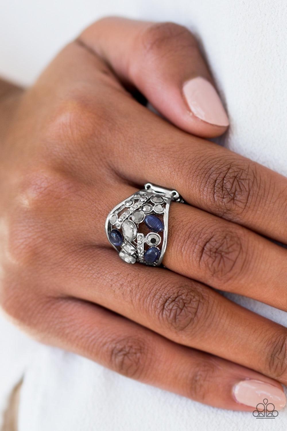 Paparazzi Accessories Let There Be STARLIGHT - Blue Dainty blue moonstones and an array of glittery rhinestones are sprinkled across a round frame, creating a collision of shimmer and sparkle. Features a stretchy band for a flexible fit. Jewelry