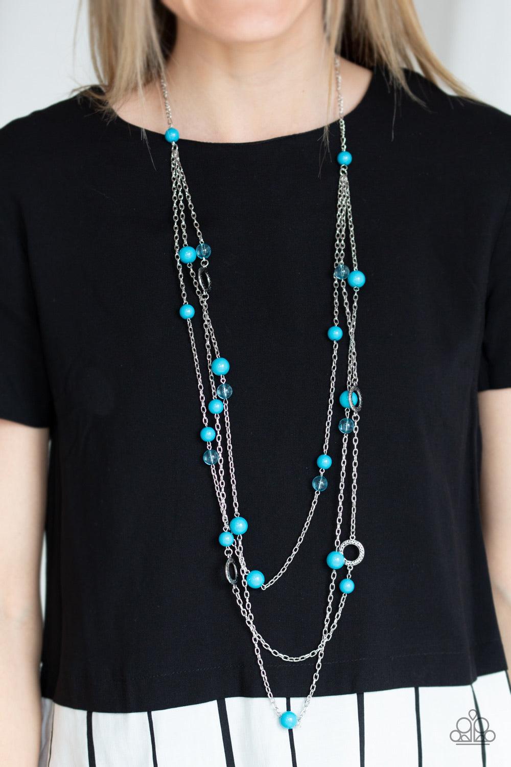 Paparazzi Accessories Brilliant Bliss - Blue A collection of glassy and polished blue beads trickle along rows of shimmery silver chains, creating colorful layers across the chest. Hammered silver hoops dot the bubbly layers, picking up and reflecting lig