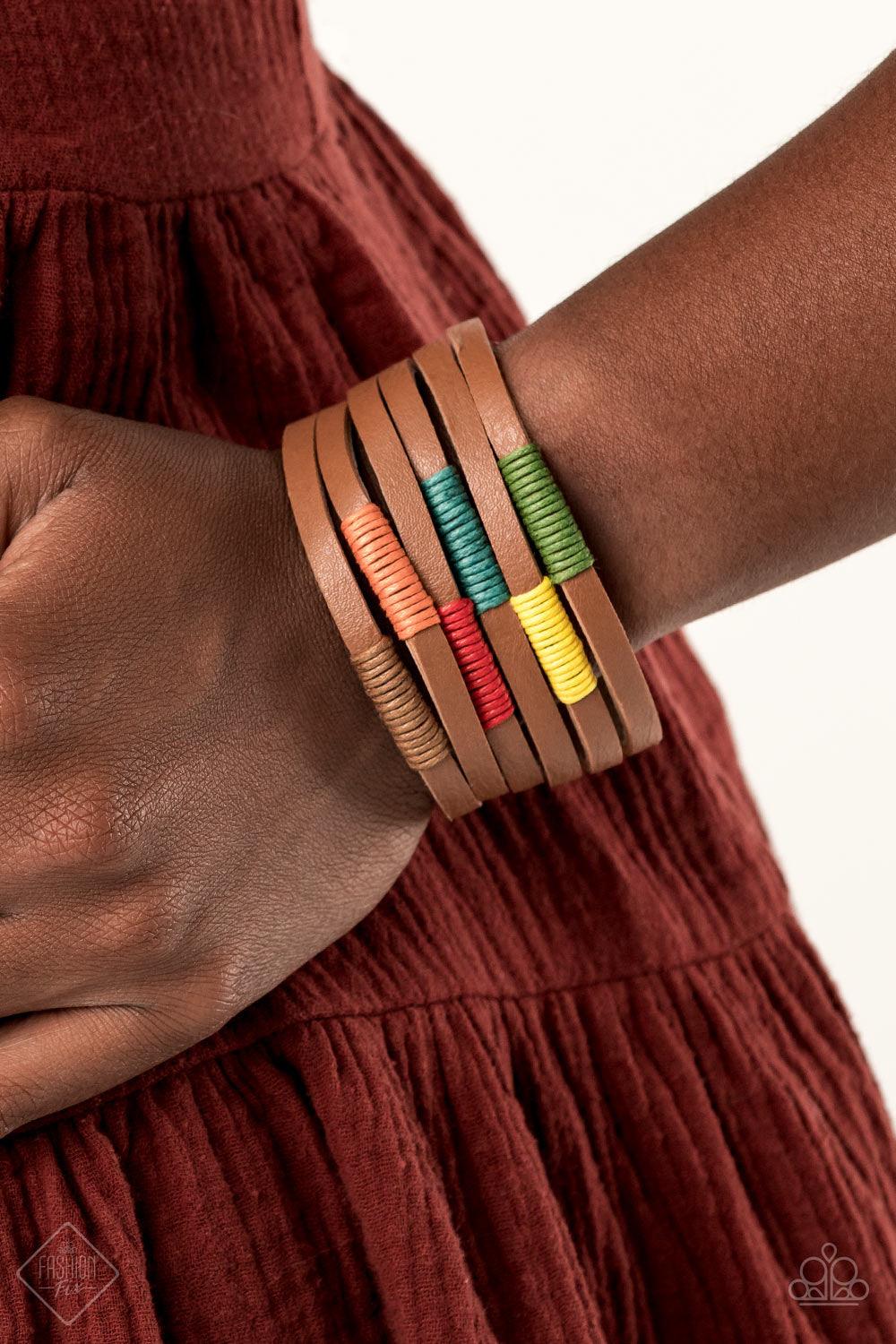 Paparazzi Accessories Country Colors - Multi A brown leather band has been spliced into layered rows that wrap around the wrist. Multicolored threaded accents wrap around the leather strips, creating a colorfully rustic display. Features an adjustable sna