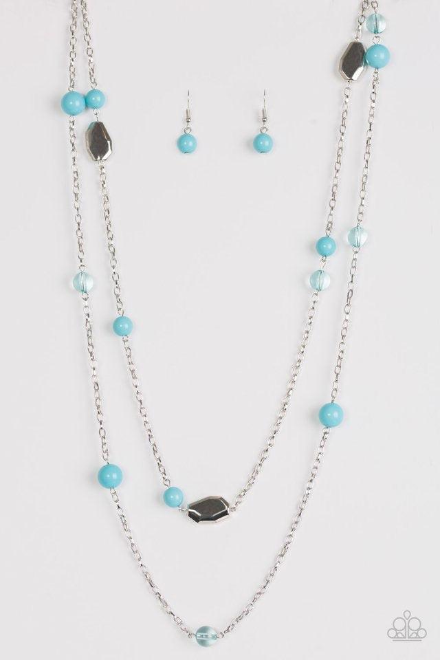 Paparazzi Accessories Hitting a GLOW Point - Blue Featuring faceted silver accents, glassy and polished blue beads trickle along strands of shimmery silver chains for a seasonal look. Features an adjustable clasp closure. Sold as one individual necklace.