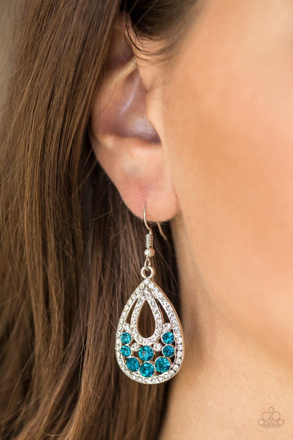 Paparazzi Accessories Sparkling Stardom - Blue Encrusted in glassy white rhinestones, shimmery silver bars swoop into a glittery teardrop frame. Sparkling blue and white rhinestones are sprinkled across the airy frame for a refined finish. Earring attache