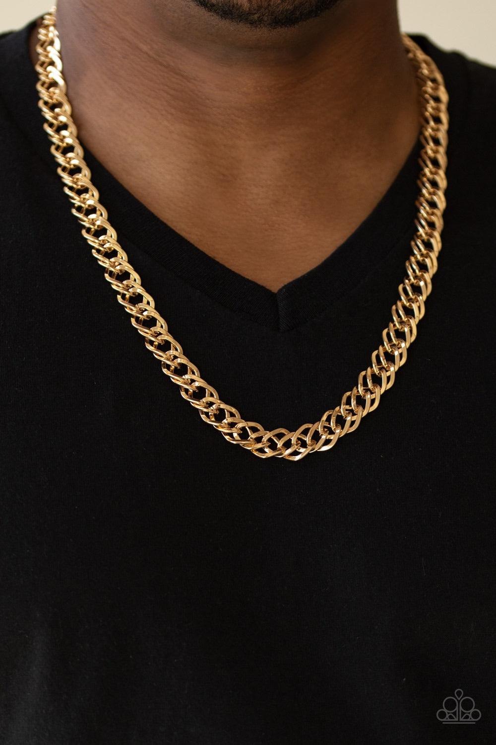 Paparazzi Accessories Undefeated - Gold Featuring doubled links, a glistening gold chain drapes across the chest for a bold look. Features an adjustable clasp closure. Jewelry