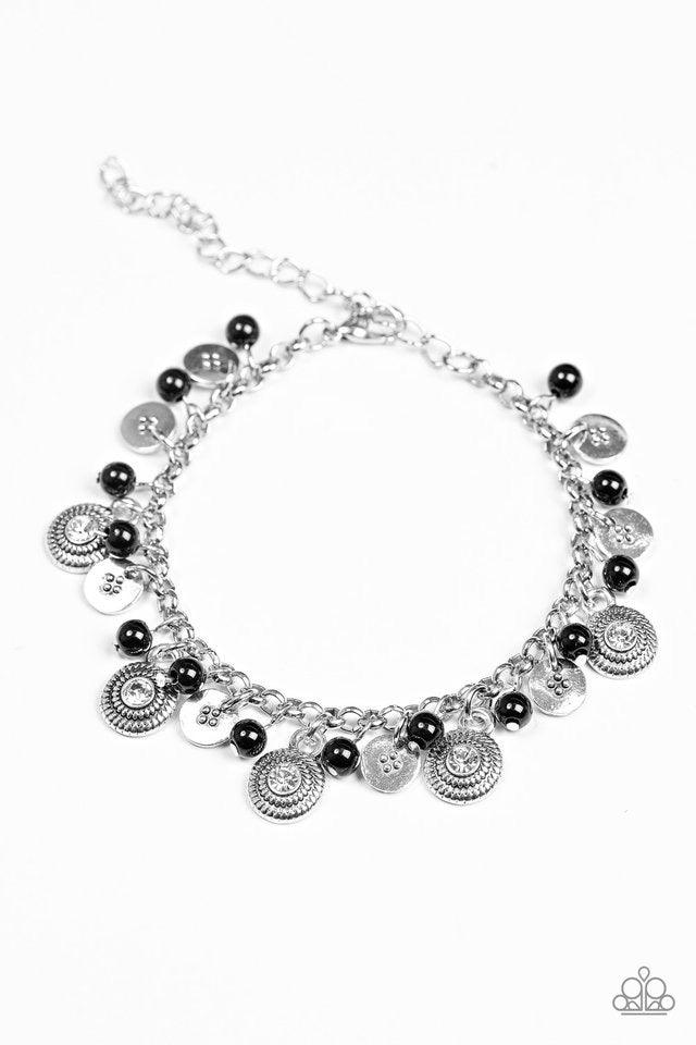 Paparazzi Accessories Pure LUXE - Black Dainty black beads and ornate silver discs swing from a shimmery silver chain, creating a casual fringe around the wrist. Featuring rhinestone centers, textured silver discs are sprinkled between refined beading for