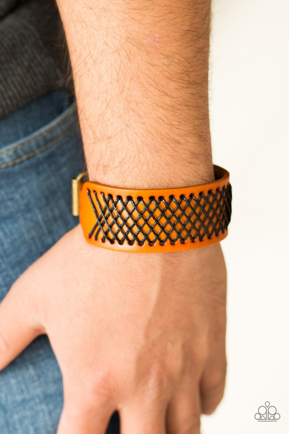 Paparazzi Accessories Cross the Line - Brown Shiny black thread is stitched across the front of a brown leather band. The crisscrossing threads create a tactile pattern around the wrist. Features an adjustable buckle closure. Jewelry