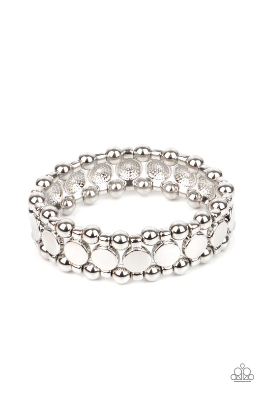 Paparazzi Accessories Metro Magnetism - Silver Shiny silver disc fittings and pairs of classic silver beads are threaded along stretchy bands around the wrist that connect into a bold industrial display around the wrist. Sold as one individual bracelet. B