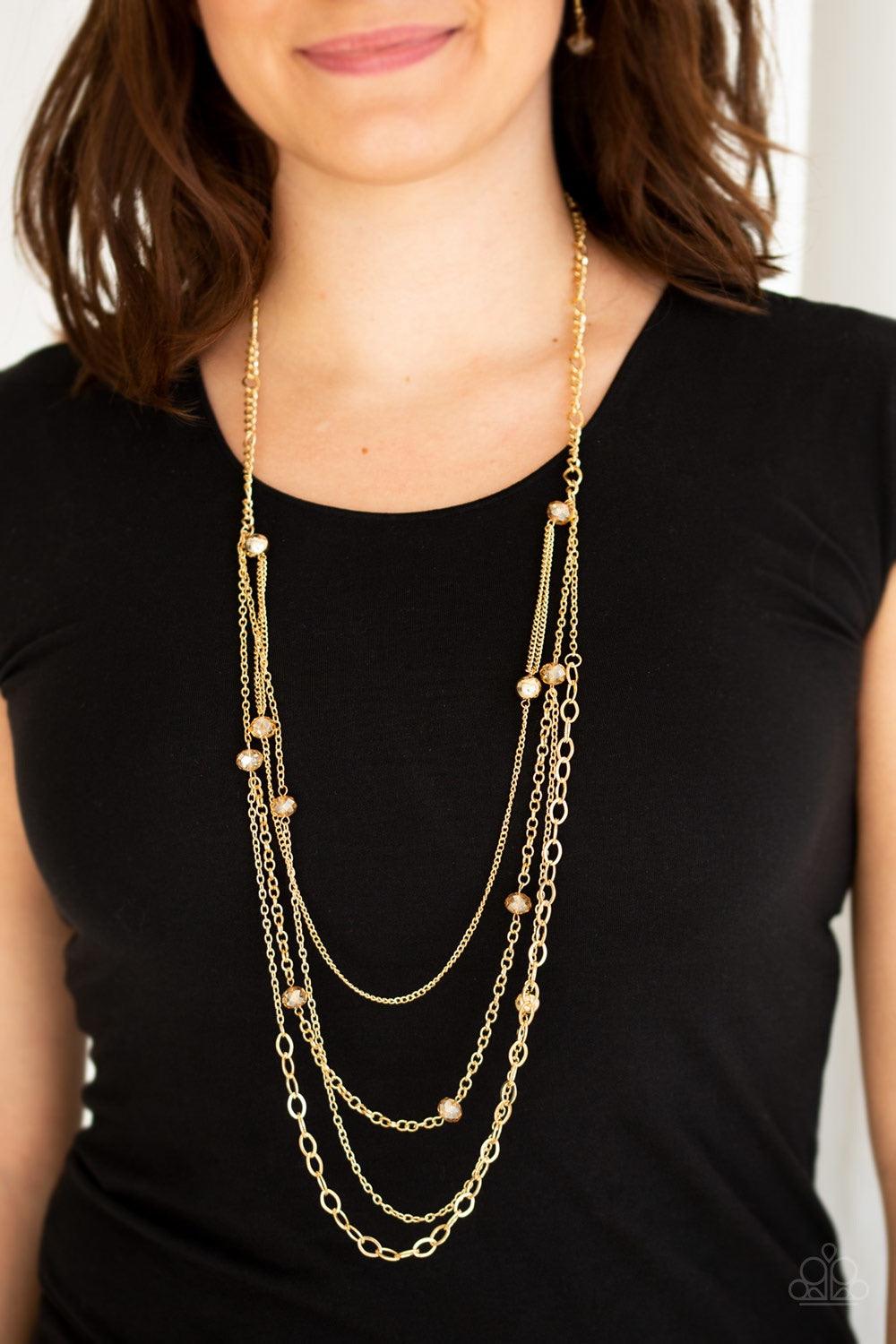 Paparazzi Accessories Glamour Grotto - Gold Golden crystal-like beads and shimmery gold beads trickle along mismatched gold chains, creating refined layers down the chest. Features an adjustable clasp closure. Jewelry