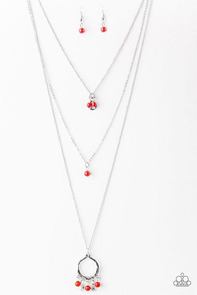 Paparazzi Accessories Texas Tempest - Red Dainty red and brown stone beading trickles from three shimmery silver chains. A hammered silver disc hangs from the uppermost chain as a large silver pendant swings from the bottom in a wanderlust fashion. Featur