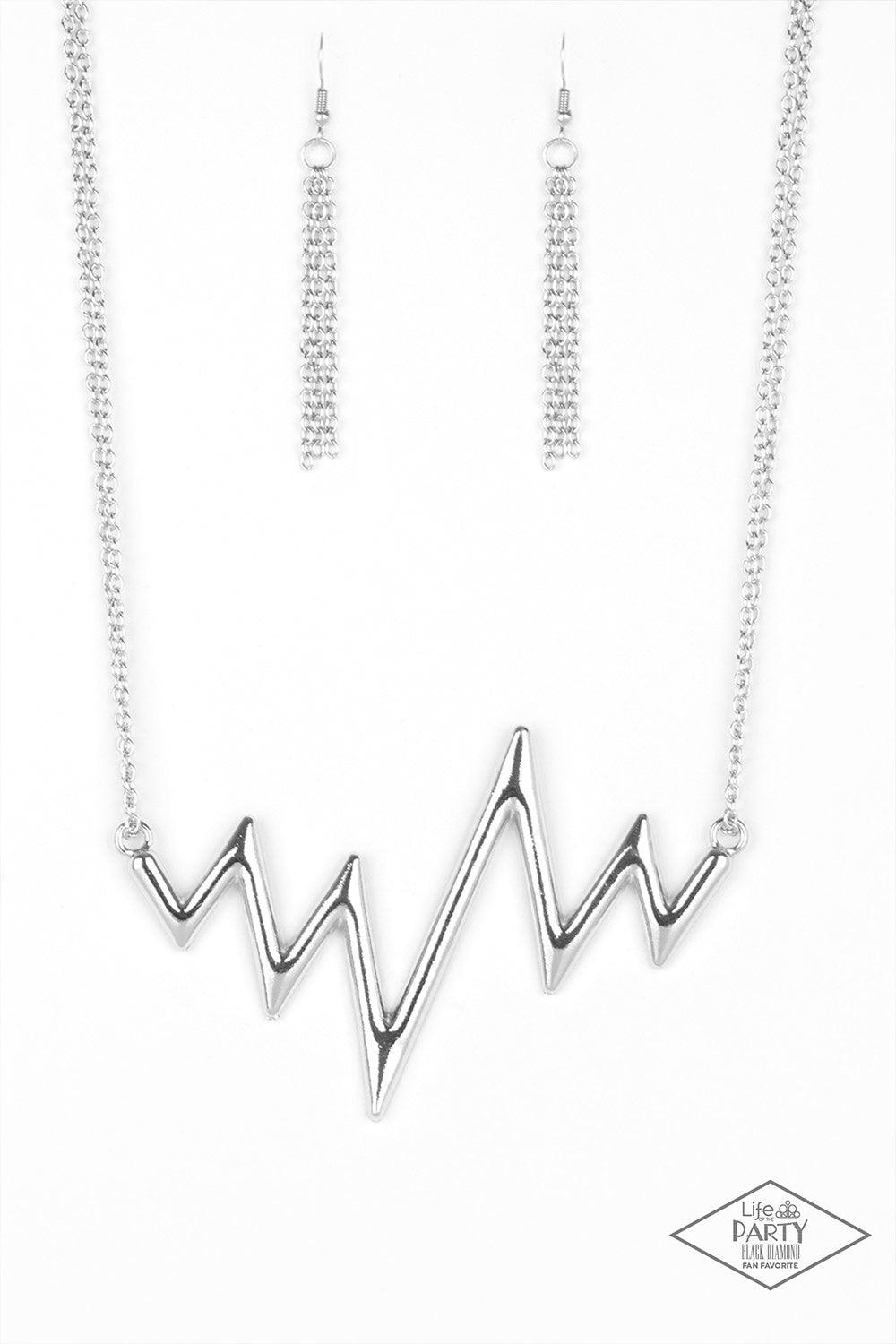 Paparazzi Accessories In A Heartbeat - Silver Chunky silver zigzags dramatically into a trendy angular design that hangs from the bottom of a glistening silver chain. Features an adjustable clasp closure. Jewelry