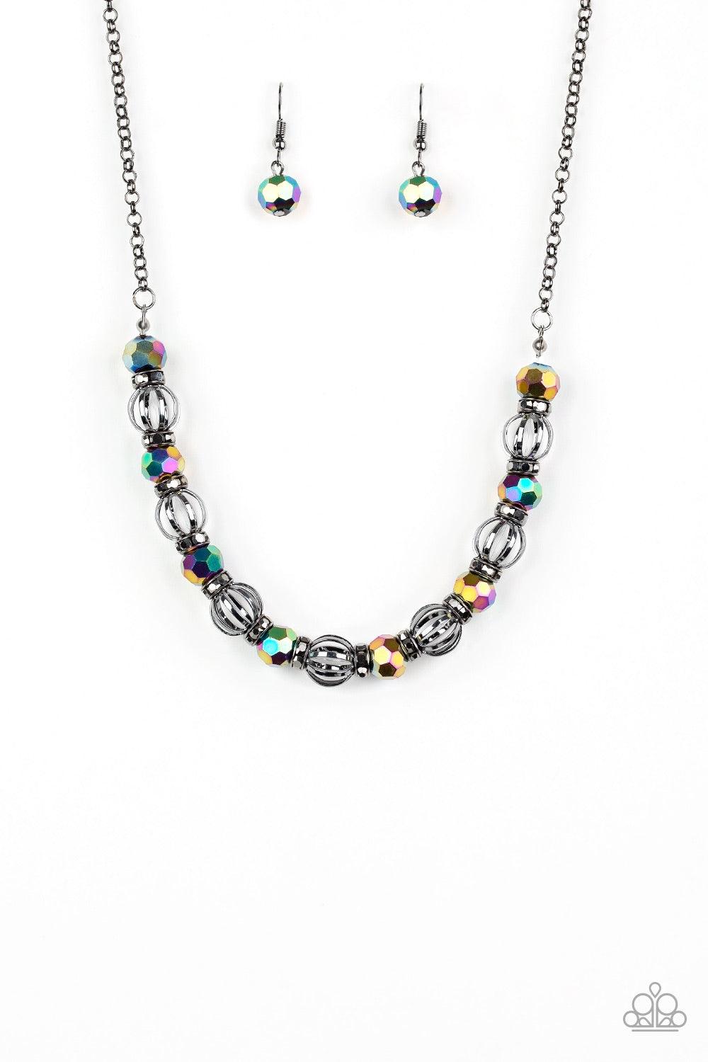 Paparazzi Accessories Metro Majestic - Multi A collection of airy gunmetal beads, faceted rainbow metallic beads, and hematite rhinestone encrusted rings are threaded along an invisible wire below the collar for a statement-making fashion. Features an adj