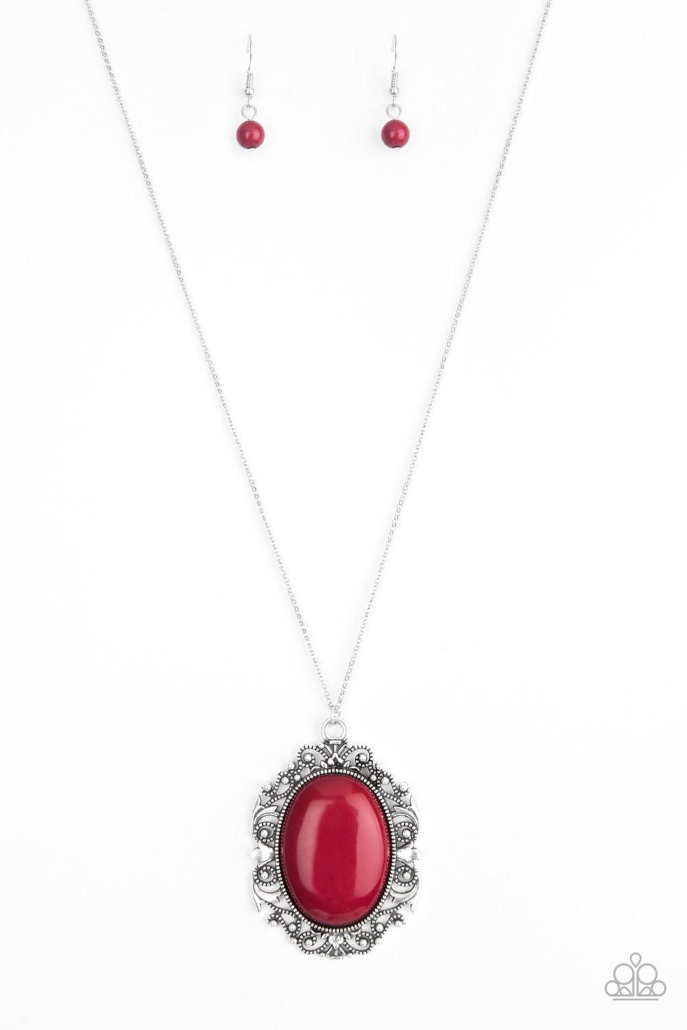 Paparazzi Accessories Vintage Vanity ~Red Featuring a faux rock finish, a robust red bead is pressed into the center of a frilly silver frame radiating with studded details. The dramatic pendant swings from the bottom of a lengthened silver chain for a vi