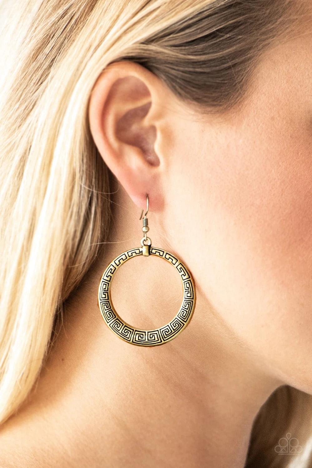 Paparazzi Accessories Mayan Mantra - Brass Brushed in an antiqued shimmer, a glistening brass hoop is stamped in dizzying patterns for a tribal inspired look. Earring attaches to a standard fishhook fitting. Sold as one pair of earrings. Jewelry