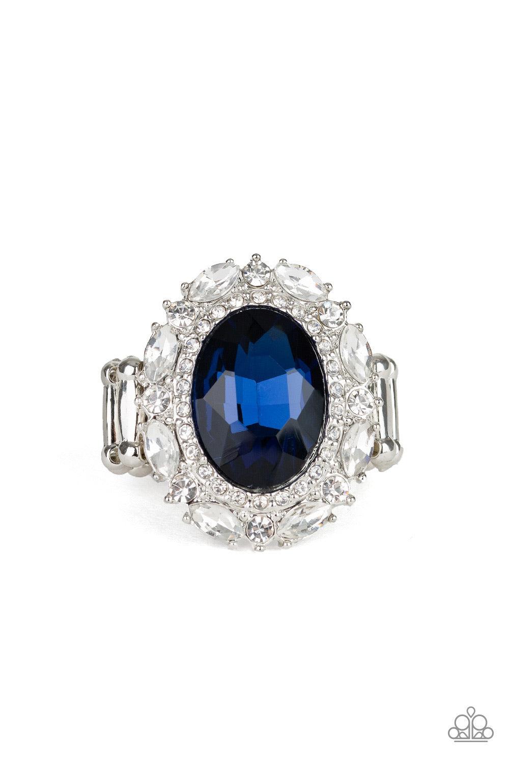 Paparazzi Accessories Show Glam - Blue An oversized oval blue gem is pressed into the center of a round silver frame encrusted in mismatched white rhinestones for a glamorous look. Features a stretchy band for a flexible fit. Jewelry