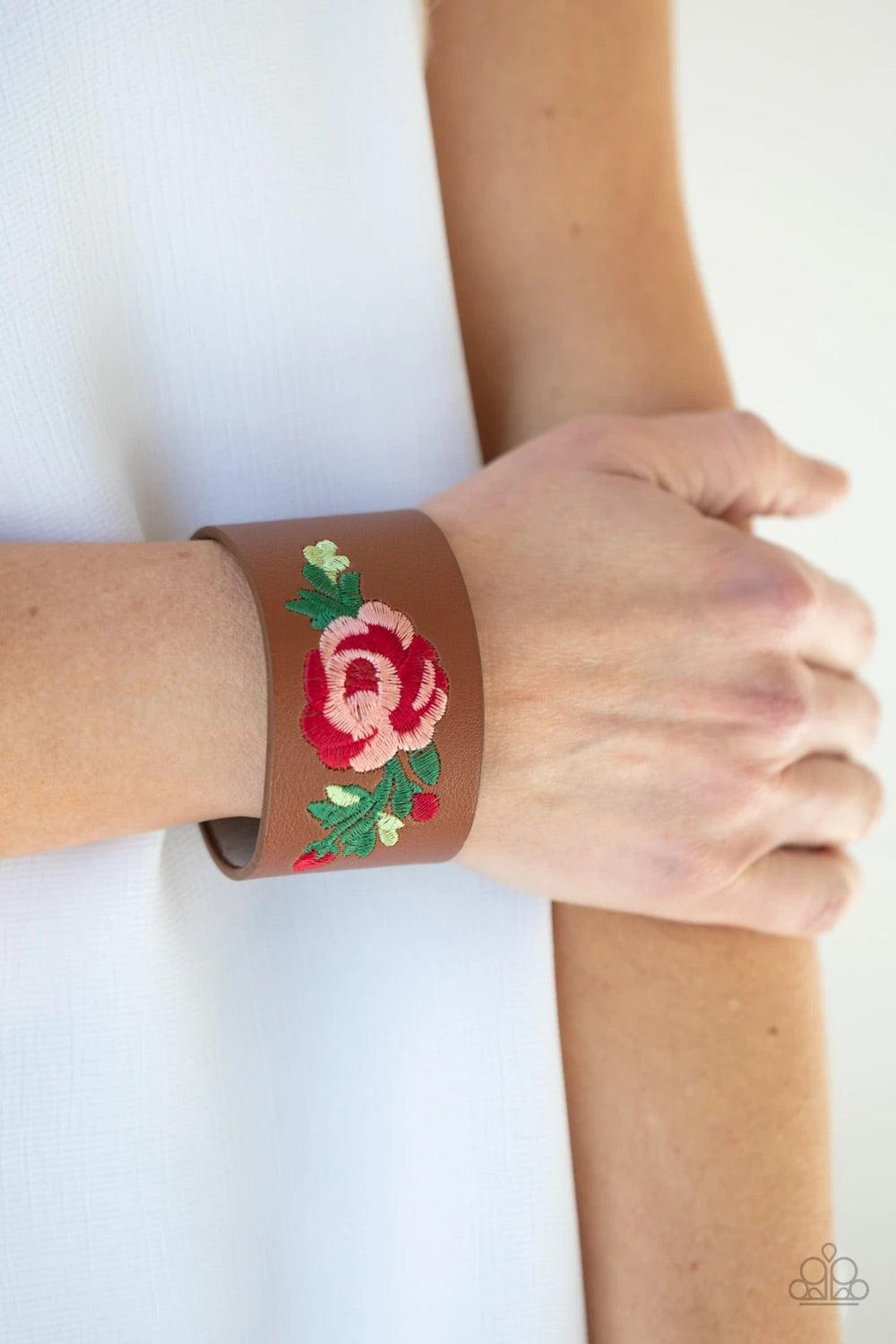 Paparazzi Accessories Rebel Rose ~Brown A leafy rose is embroidered across the center of a thick leather band, adding a hint of girly girl glam to the seasonal centerpiece. Features an adjustable snap closure. Sold as one individual bracelet. Jewelry