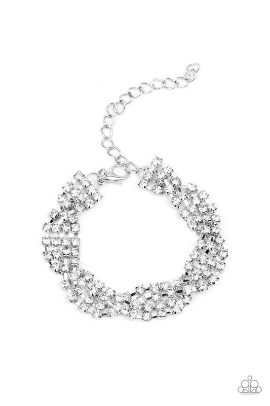Paparazzi Accessories Twists And Turn - White Featuring glistening silver fittings, strands of glittery white rhinestones delicately braid around the wrist for a glamorously layered look. Features an adjustable clasp closure. Sold as one individual bracel