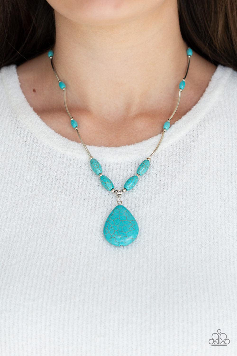 Paparazzi Accessories Explore the Elements - Blue A collection of shiny silver beads and refreshing turquoise stone beads are threaded along an invisible wire below the collar. A dramatically oversized turquoise teardrop pendant swings from the bottom of