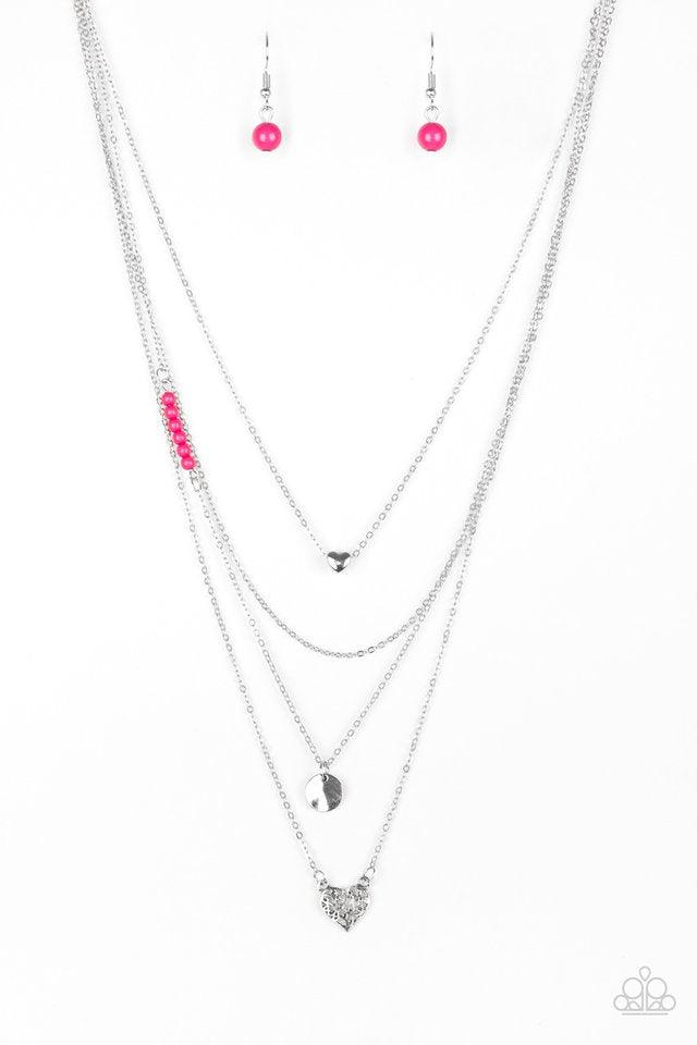 Paparazzi Accessories Gypsy Heart - Pink Shimmery silver layers cascade below the collar. Infused with hints of vivacious pink beading, dainty silver hearts and a delicately hammered silver disc swing from the bottoms of the chains for a whimsical finish.